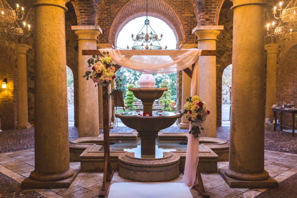 bella collina fountain wedding ceremony location orlando florida wedding arch florals drapery